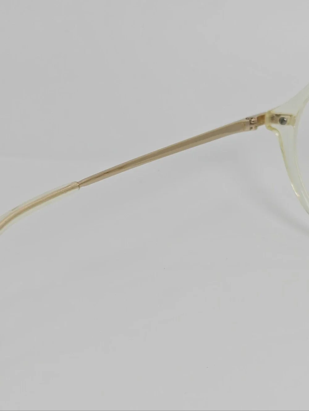 Tamara. Clear Round Frame Glasses. All Gold Accents are Metal.